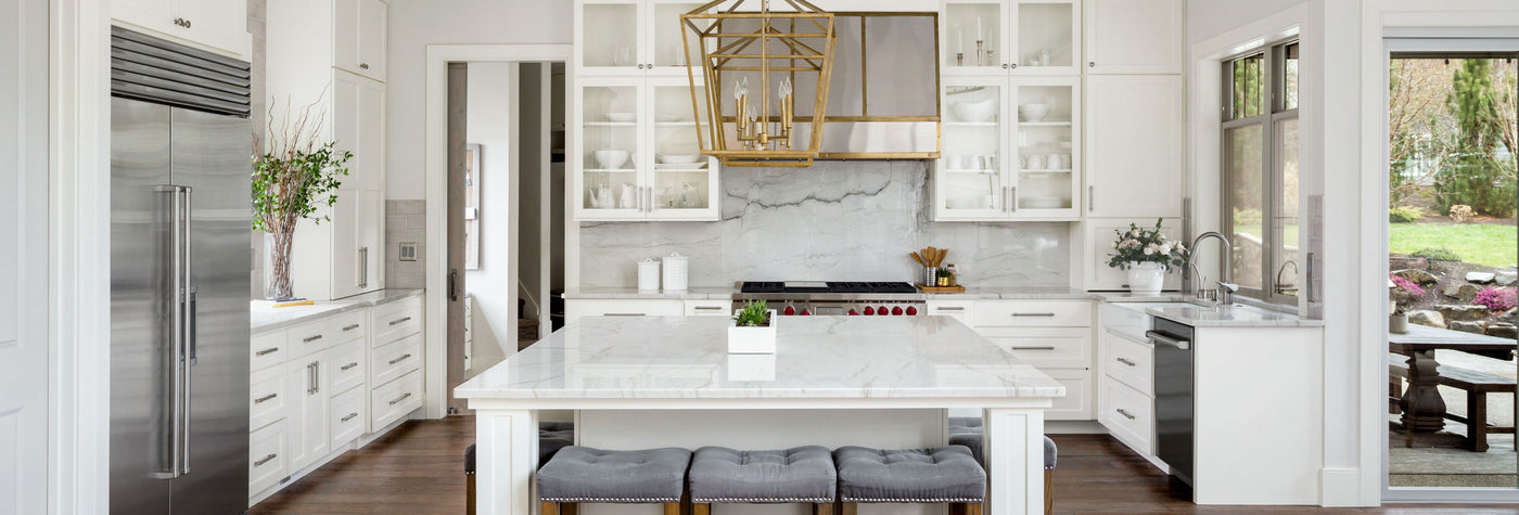 Luxurious white kitchen with stainless steel appliances